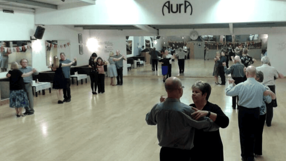 Adult couples enjoying a sequence dance class at AURA
